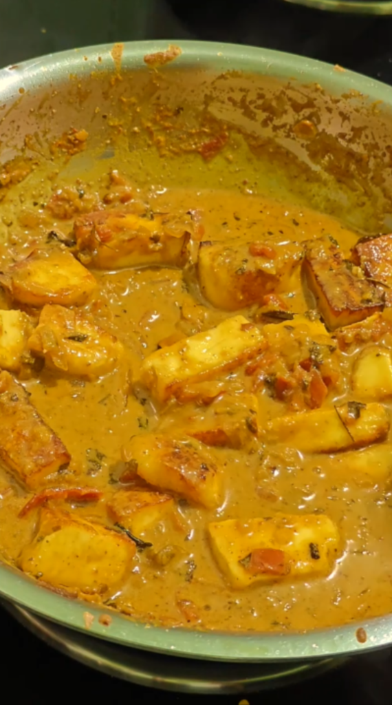 Fried paneer cubes simmering in creamy masala gravy