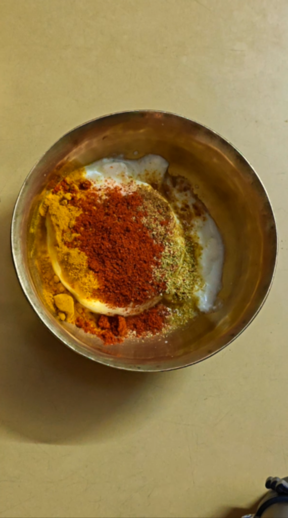 Yogurt topped with turmeric, chilli, cumin, and coriander powders
