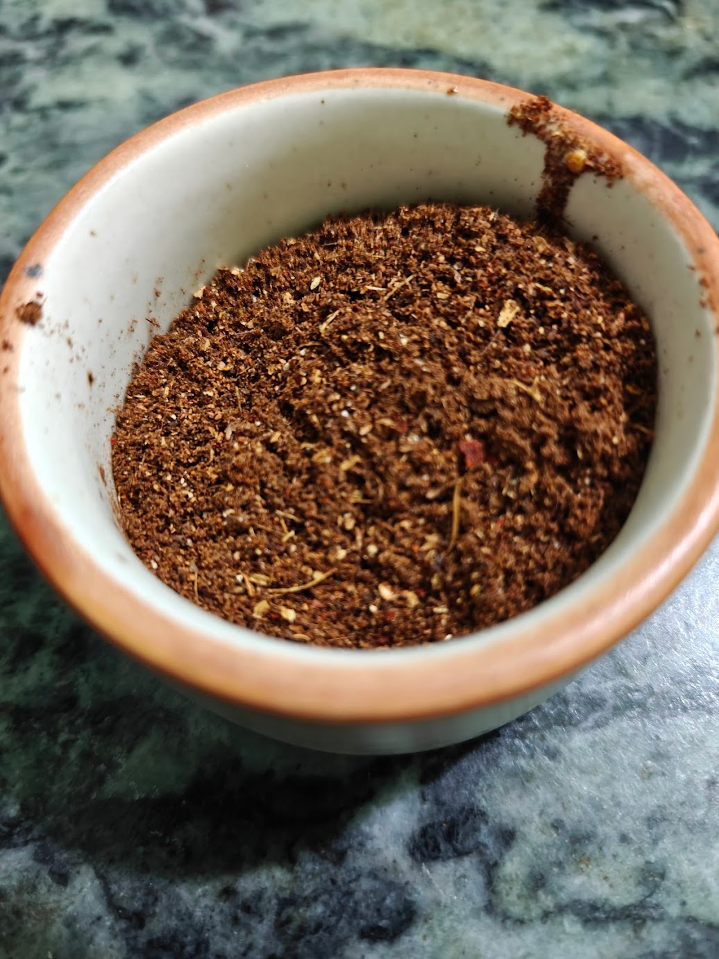 Freshly ground Kadai Paneer spice mix in a small bowl