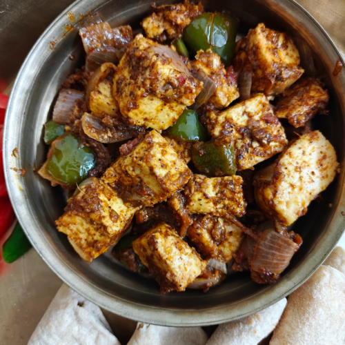 Kadai Paneer served in a plate along with chapatis