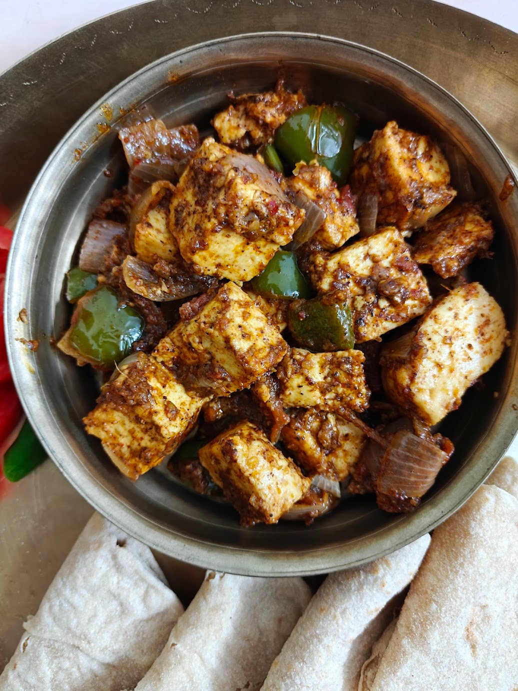 Homemade Kadai Paneer served in a bowl with soft chapatis