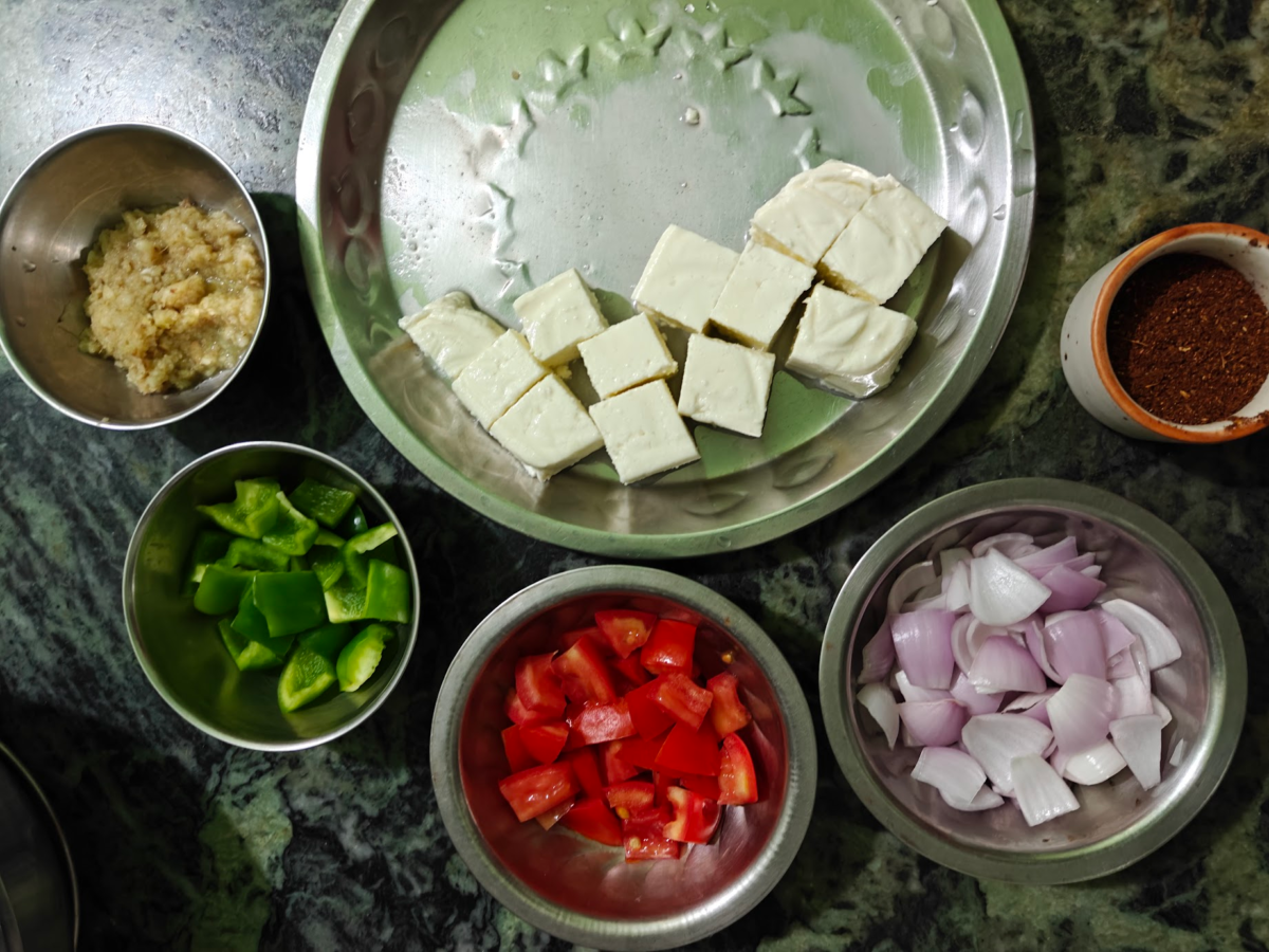 Paneer cubes, spice mix, onions, tomatoes, bell peppers and onion-garlic paste
