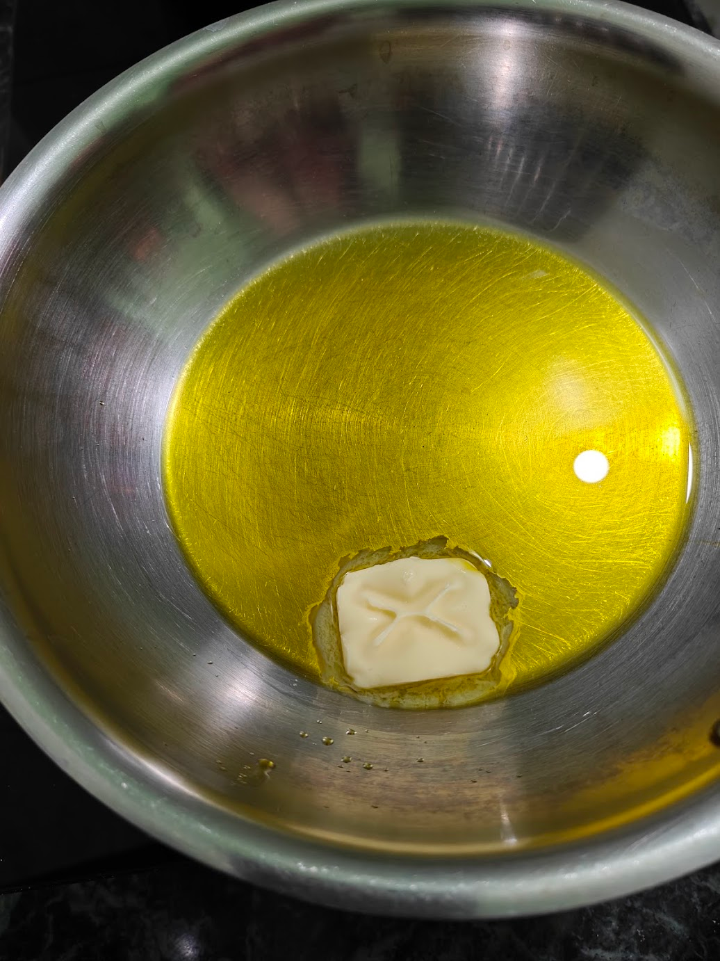 Oil and butter heating together in a pan for Kadai Paneer