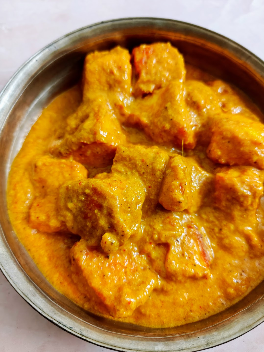 Paneer butter masala with golden paneer cubes in creamy tomato-cashew gravy.