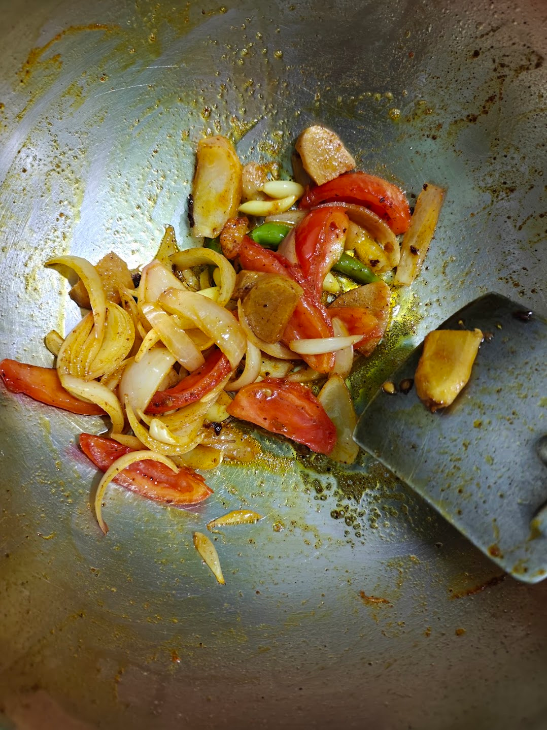 Softened tomatoes, onions, ginger, garlic and green chillies after sautéing.