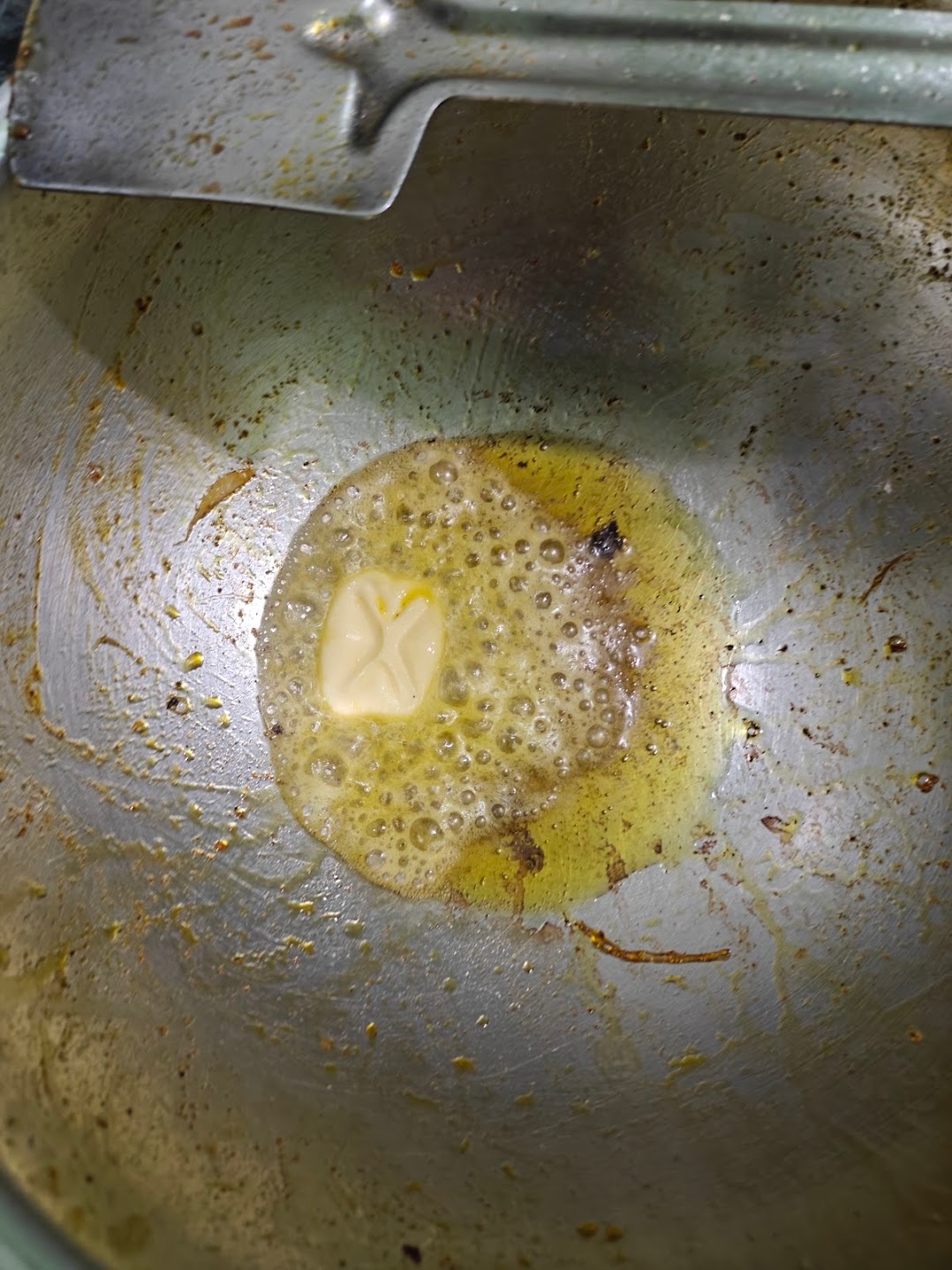 Butter melting and bubbling in the pan before adding the blended gravy.