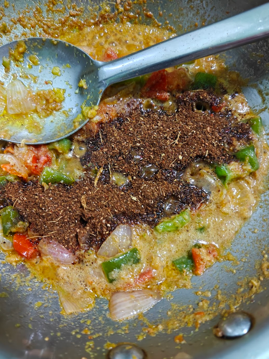 Freshly ground Kadai masala added to the onion, tomato and bell pepper gravy